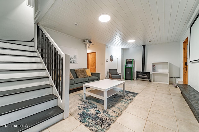 tiled living room featuring wood ceiling and a wood stove