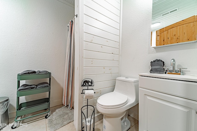 bathroom with vanity, toilet, and tile patterned flooring