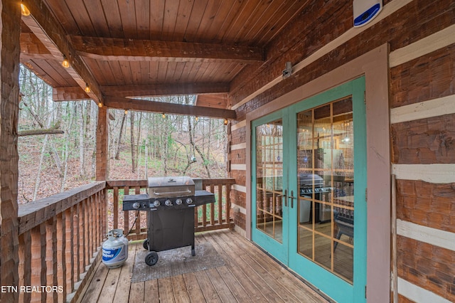 wooden deck featuring grilling area and french doors