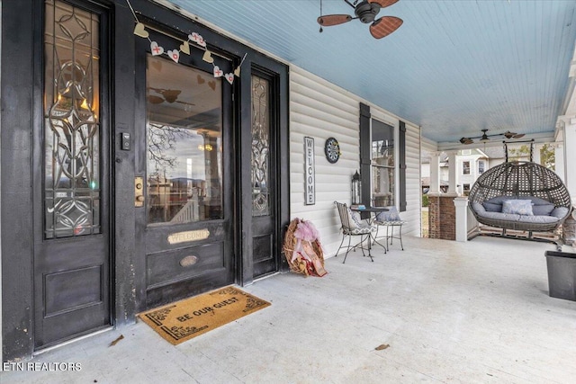 entrance to property featuring ceiling fan and covered porch