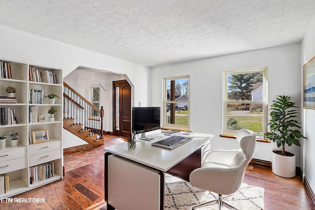 office area featuring light hardwood / wood-style floors and a textured ceiling