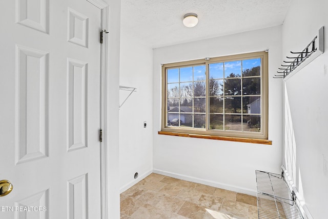 laundry room with a textured ceiling