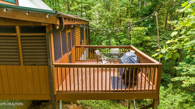 1521 Dawn Ln, Sevierville, TN 37876 - wooden deck with outdoor dining area and a forest view