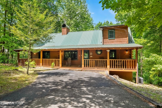 1521 Dawn Ln, Sevierville, TN 37876 - view of front of property featuring a porch, a chimney, and log exterior