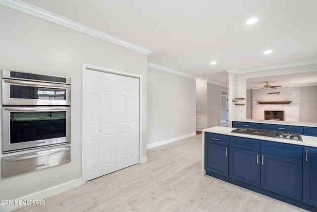 kitchen with ornamental molding, appliances with stainless steel finishes, blue cabinets, and a warming drawer