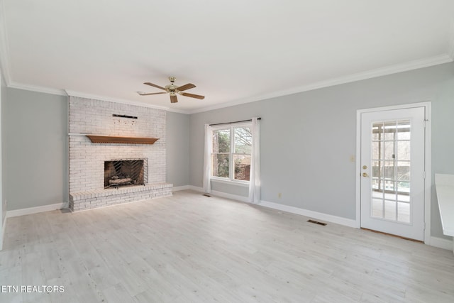 unfurnished living room with visible vents, a ceiling fan, wood finished floors, crown molding, and baseboards