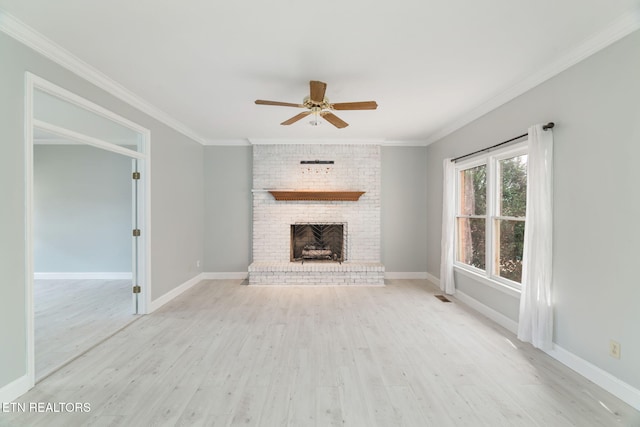 unfurnished living room with a ceiling fan, visible vents, light wood finished floors, and ornamental molding