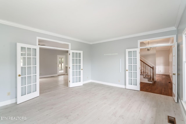 unfurnished room with stairs, wood finished floors, french doors, and visible vents