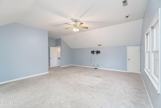 additional living space featuring lofted ceiling, a ceiling fan, visible vents, and baseboards