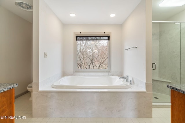 bathroom featuring tile patterned floors, a shower stall, vanity, and toilet