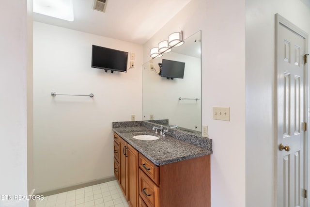 bathroom featuring tile patterned floors, visible vents, vanity, and baseboards