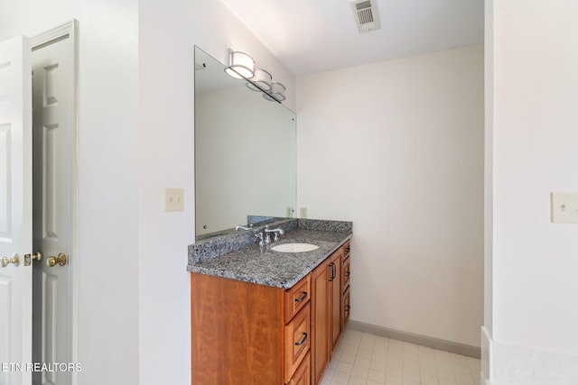 bathroom featuring visible vents, baseboards, and vanity