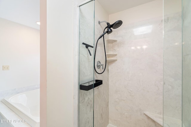 bathroom featuring a bath and a walk in shower