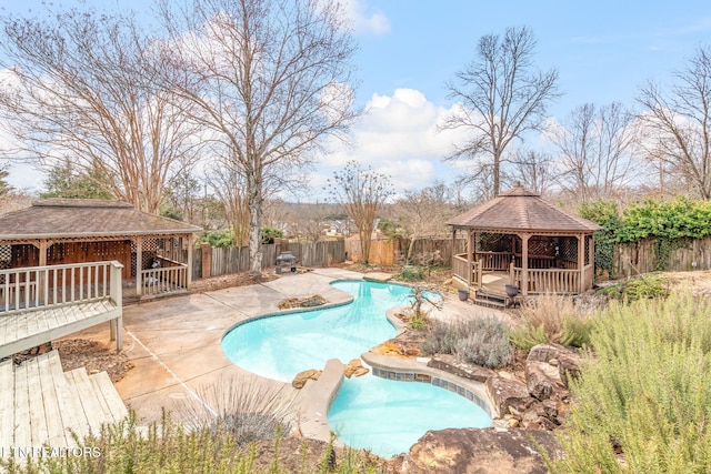 view of swimming pool with a deck, a patio, a fenced backyard, a gazebo, and a fenced in pool