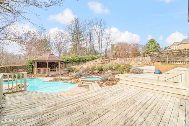 view of pool with a deck, fence, a gazebo, a fenced in pool, and an in ground hot tub