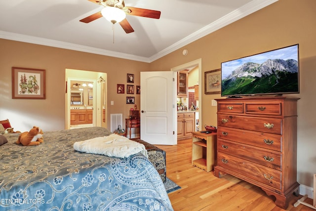 bedroom featuring crown molding, light hardwood / wood-style floors, ceiling fan, and ensuite bathroom