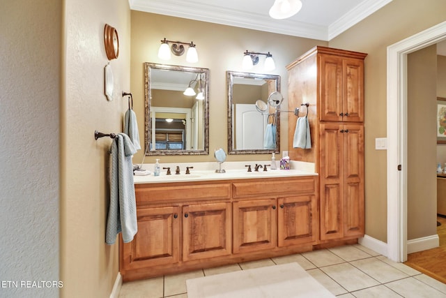 bathroom with tile patterned flooring, ornamental molding, and vanity