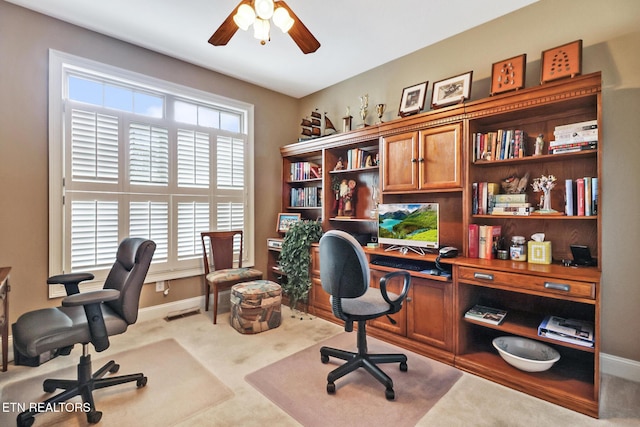 carpeted office with plenty of natural light and ceiling fan