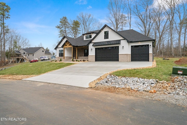 modern farmhouse with brick siding, a front lawn, concrete driveway, metal roof, and a standing seam roof