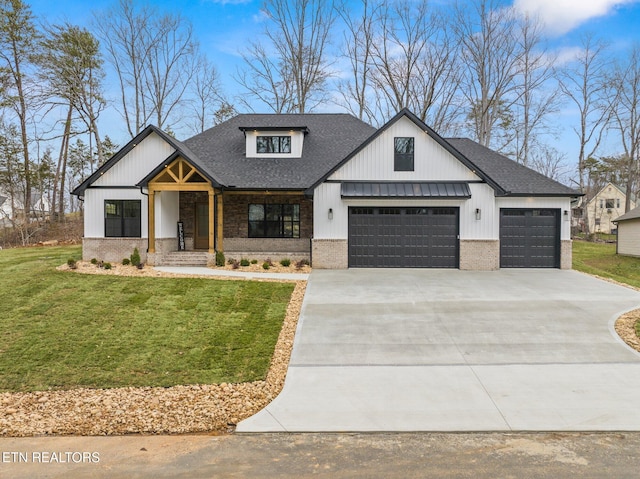 modern farmhouse with brick siding, concrete driveway, a front yard, roof with shingles, and a garage