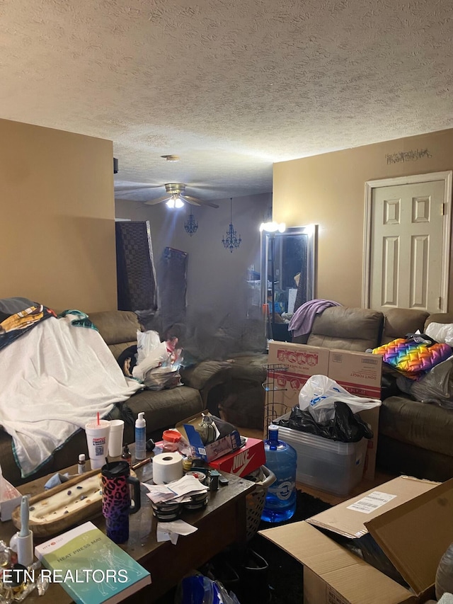 living room with ceiling fan and a textured ceiling