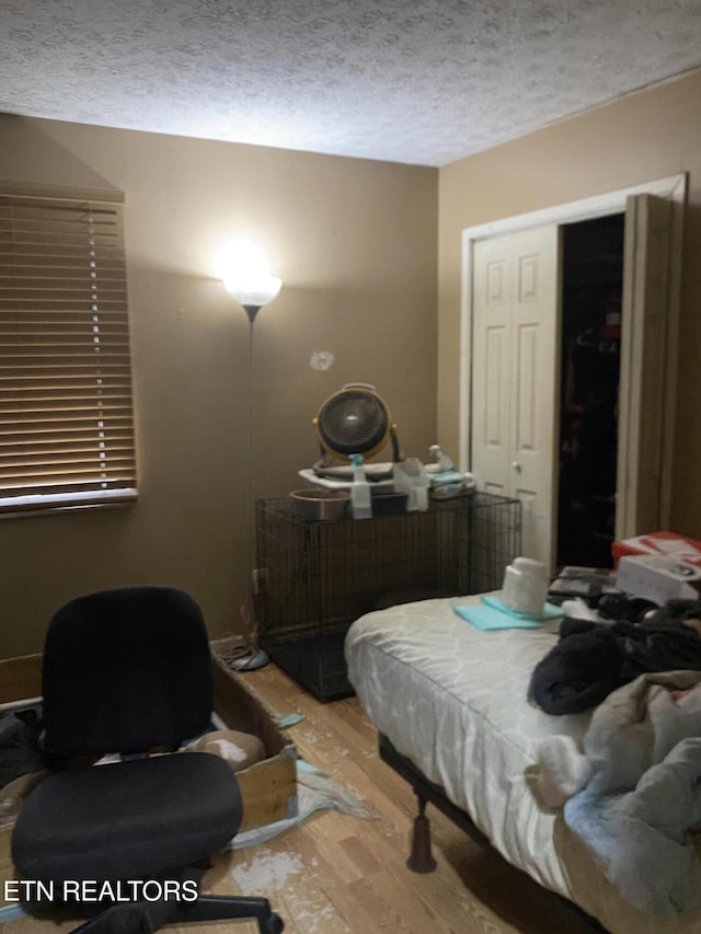 bedroom featuring a textured ceiling and light wood-type flooring