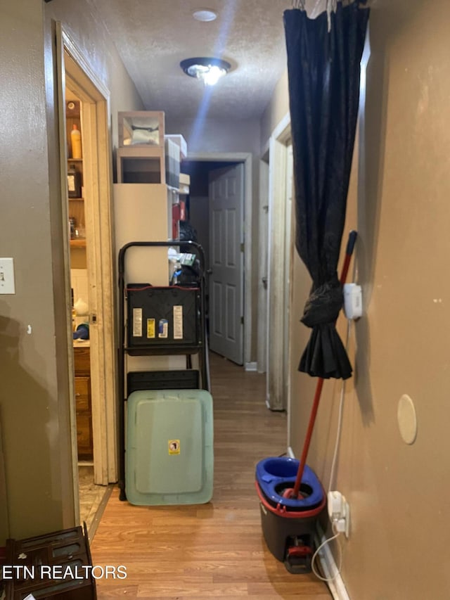 corridor with light hardwood / wood-style floors