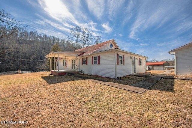 exterior space with a front yard and covered porch