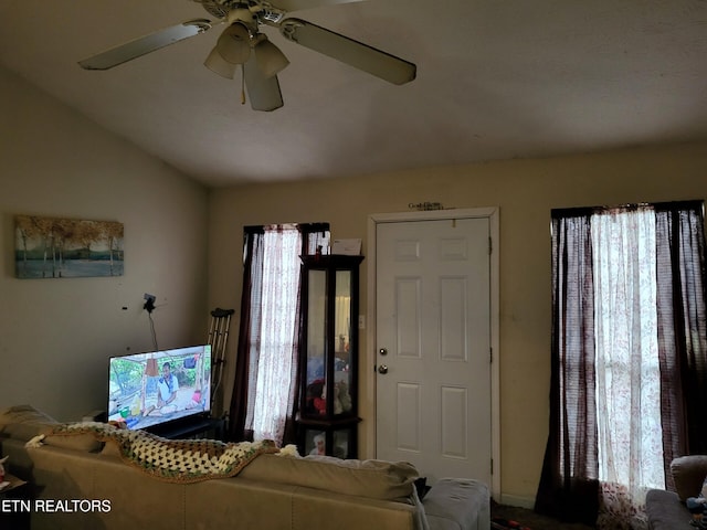 living room with ceiling fan and lofted ceiling