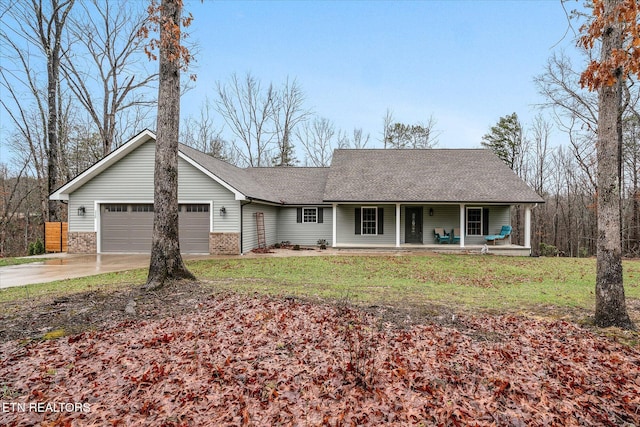 single story home featuring a garage, a porch, and a front yard