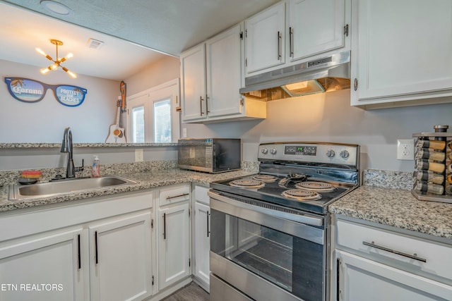 kitchen with white cabinetry, light stone counters, sink, and stainless steel range with electric cooktop