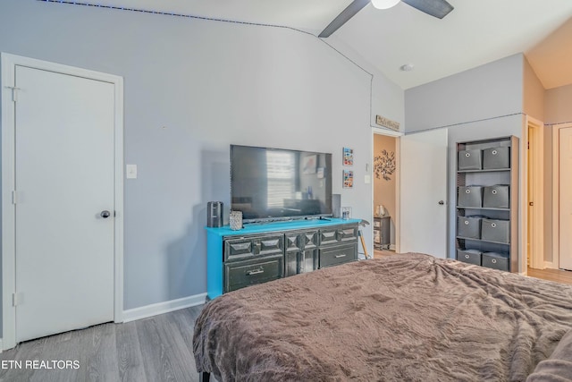 bedroom featuring wood-type flooring, lofted ceiling, and ceiling fan