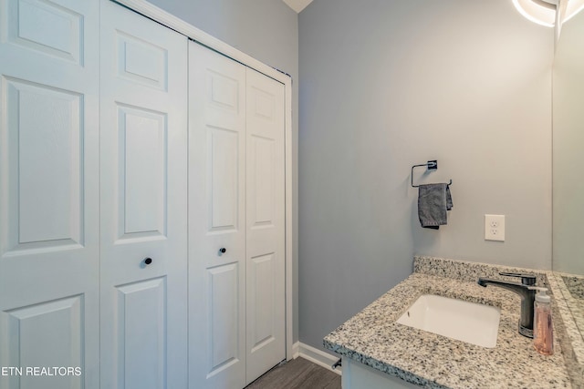 bathroom with vanity and hardwood / wood-style floors