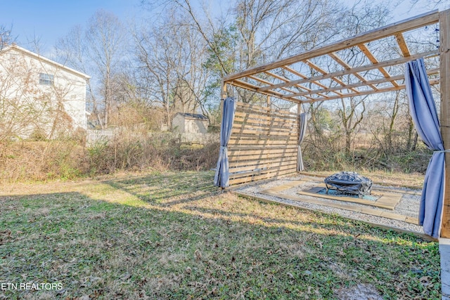 view of yard with a fire pit