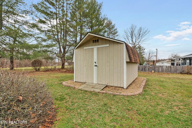 view of outbuilding featuring a lawn