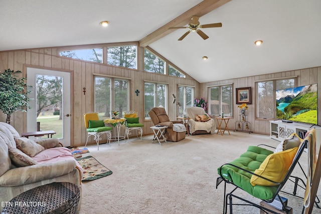 sunroom / solarium with vaulted ceiling with beams, plenty of natural light, and ceiling fan