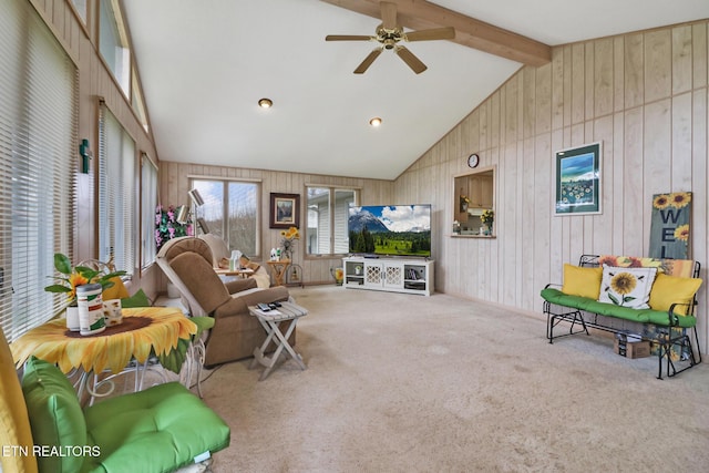 living room featuring ceiling fan, carpet, high vaulted ceiling, and beam ceiling