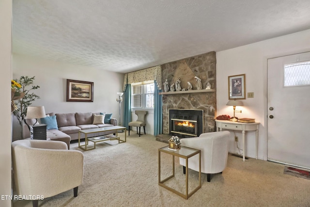 carpeted living room with a fireplace and a textured ceiling