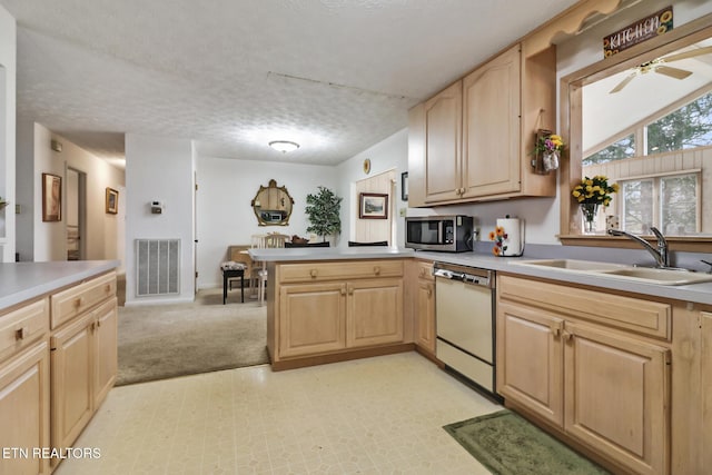 kitchen featuring light brown cabinetry, sink, a textured ceiling, white dishwasher, and ceiling fan