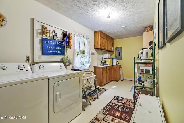 washroom featuring cabinets, electric panel, independent washer and dryer, and a textured ceiling