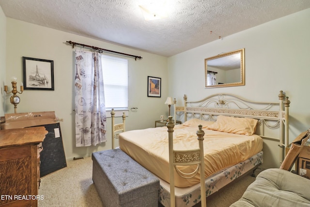 carpeted bedroom featuring a textured ceiling