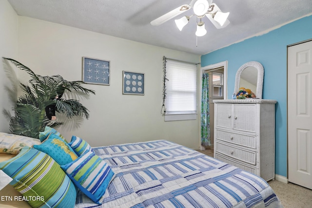 bedroom with a textured ceiling and ceiling fan