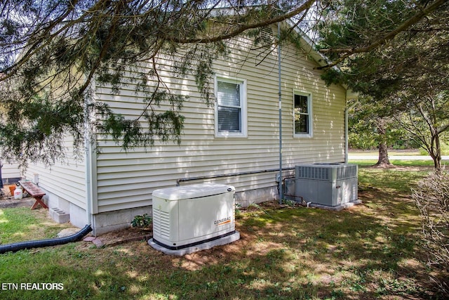 view of side of property featuring central air condition unit