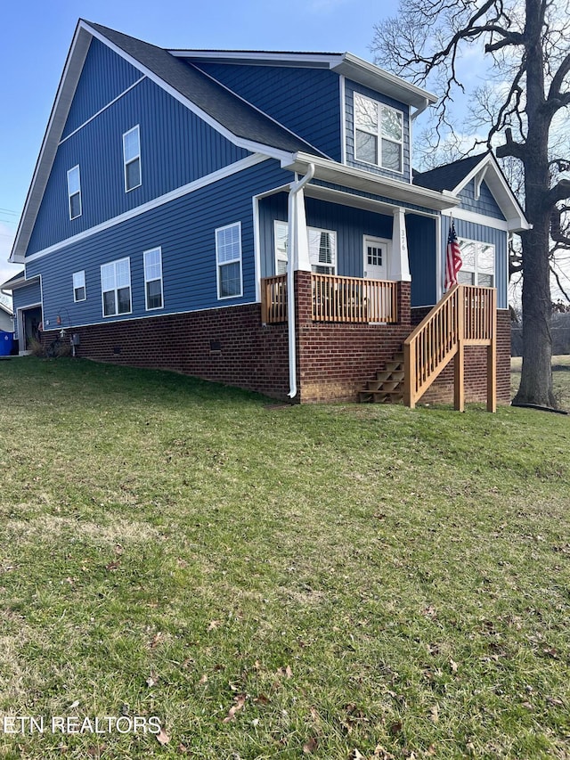 back of house featuring a porch and a yard