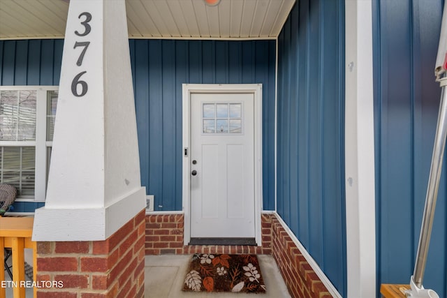 doorway to property with brick siding