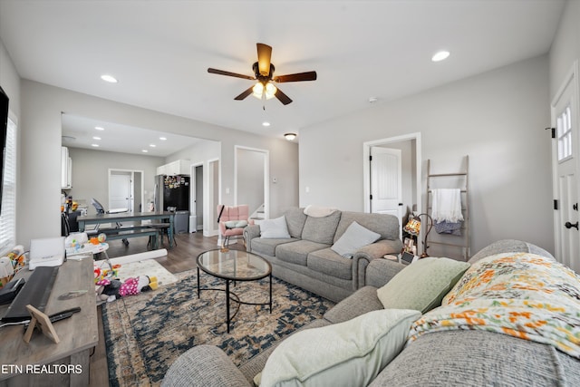 living area featuring wood finished floors, a ceiling fan, and recessed lighting