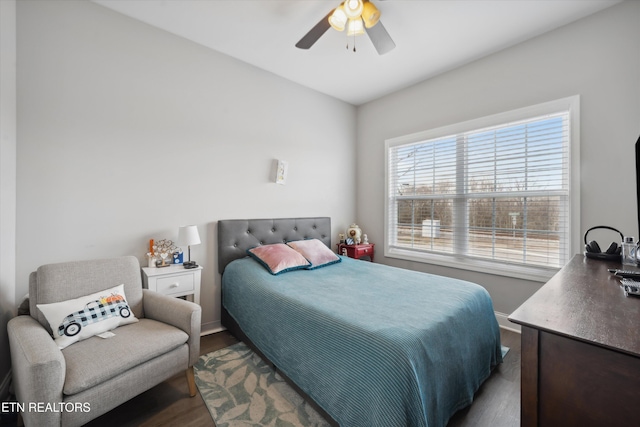 bedroom with dark wood-style floors, baseboards, and a ceiling fan