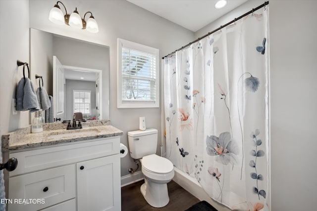 bathroom with toilet, wood finished floors, vanity, baseboards, and a shower with curtain