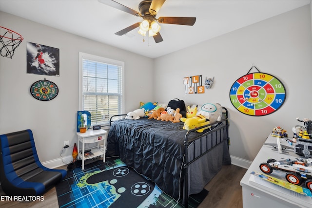 bedroom with dark wood-type flooring, baseboards, and a ceiling fan