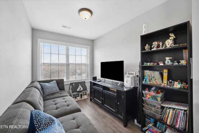 living room with visible vents and wood finished floors